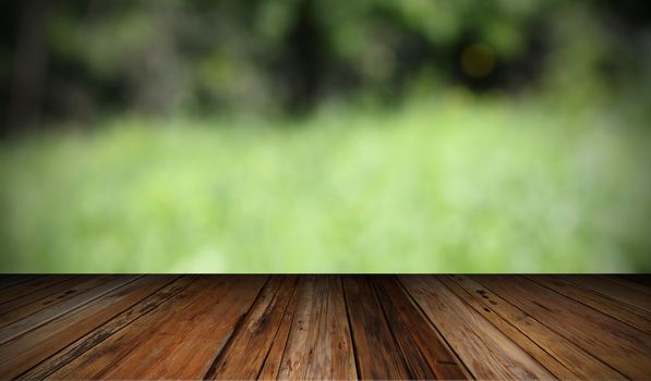 natural backdrop with wooden  terrace and out of focus green field