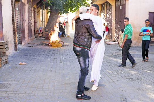 FES, MAROCCO - October 15 2013: Friends give best wishes on on Eid al-Adha. The festival is celebrated by sacrificing a sheep and distributing the meat to relatives, friends, and the poor.