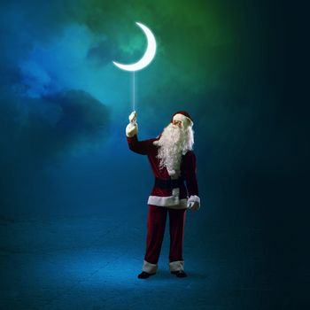 Santa Claus holding a string of luminous glowing moon