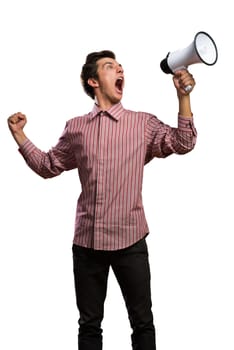 Portrait of a young man shouting using megaphone, isolated on white
