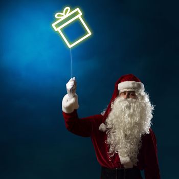 Santa Claus holding a shining light symbol of the Christmas box for thread