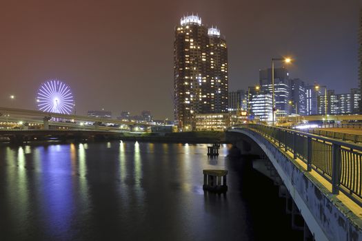 modern city well illuminated by night with scenic water reflection