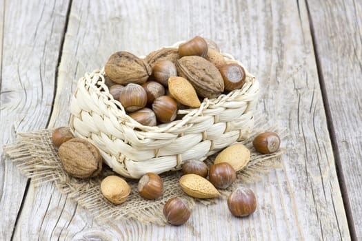 nuts in a basket on old wooden background