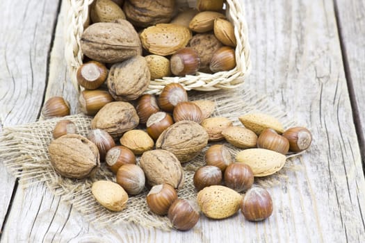 nuts in a basket on old wooden background