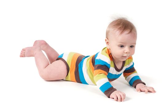 Cute kid in a striped body lying on his tummy, isolated