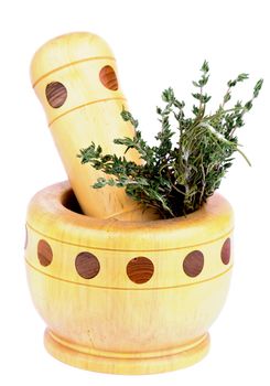 Arrangement of Wooden Mortar and Pestle and Bunch of Rosemary and Thyme isolated on white background