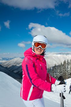 Young woman on skis in soft snow in the mountains