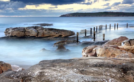 Idyllic Mahon rock pool, Maroubra, near Sydney Australia at early dawn, that is filled by surging tidal swells from the Tasman Sea