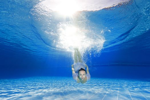 athletic girl diving in the swimming pool