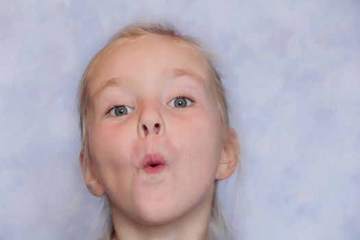 Portrait of beautiful girl with blond hair and blue eyes