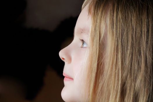 Portrait of girl's profile with blue eyes