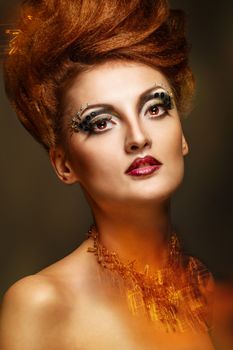 Close-up portrait of a young and attractive girl with hairstyle and jewelry