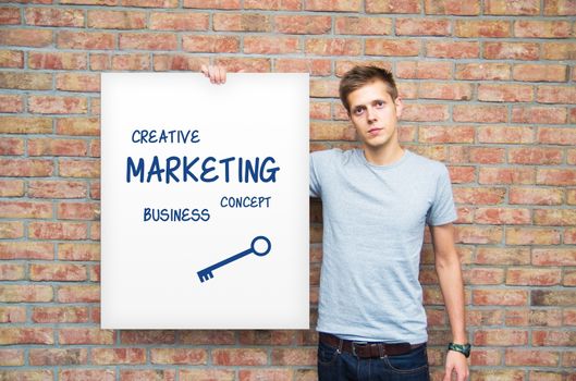 Young man holding whiteboard with marketing content. Business presentation.