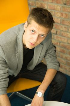 Portrait of a young businessman sitting in an office chair