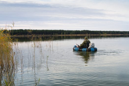 Hunter is floating in an inflatable boat on the lake