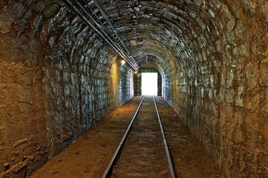 Mining tunnel with lights and rails