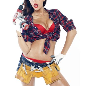 High fashion glamour model in Daisy duke shorts, tool belt, red bra with a screw gun