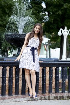 Portrait of young woman in white dress