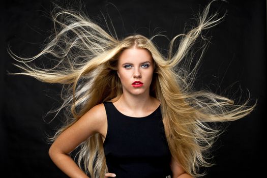 Portrait of beautiful woman in dark studio