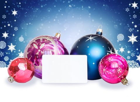 New Year's background. Christmas balls, snowflakes and white card on abstract background