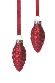 red christmas balls, form pine cone hanging isolated with red ribbon and white background 
