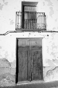 Full frame take of a weathered Mediterranean village house facade