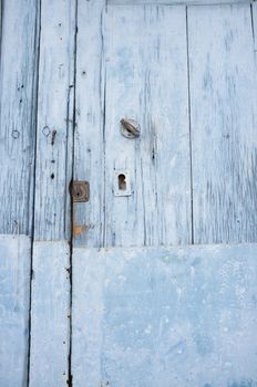 Old blue wooden door with rusty locks