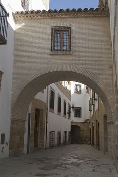 Typical Street of the world heritage city in Baeza, Street Barbacana next to the clock tower, It is characterized by the union of two houses with a passage, Baeza, Jaen province, Andalucia, Spain