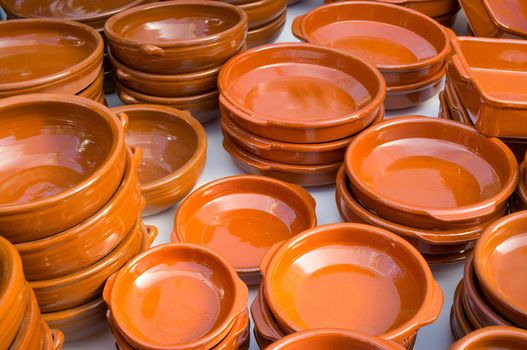 Handcrafted earthenware pots and pans on display on a street market