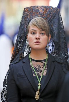 Woman dressed in mantilla during a procession of holy week, Spain