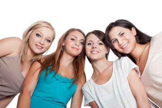 Four attractive young woman looking down at the camera with their heads close together isolated on white