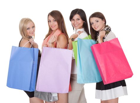 Four happy beautiful female shoppers carrying colorful shopping bags isolated on white