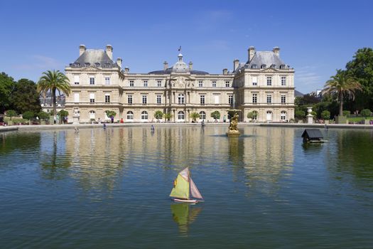 Traditional small wooden sailing boat in the pond of park Jardin du Luxembourg, Paris, France