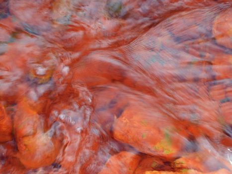 playful ripples pink color ferrous water of a river