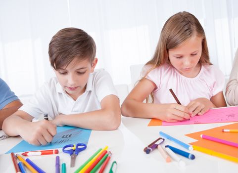 Portrait Of Girl and Boy Drawing With Colorful Markers At Home