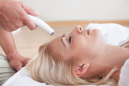 Profile View Of Happy Young Woman During Cosmetic Treatment, Indoors
