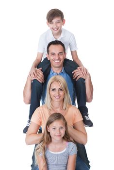 Portrait Of Family With Son On Father's Shoulder Isolated On White Background