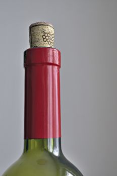closed red wine bottle; focus on cork