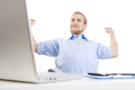 young man at office, sitting leaning back daydreaming, smiling