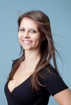 portrait of a young beautiful woman with brown hair - isolated on blue