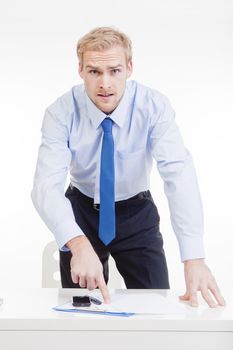 angry boss standing behind desk, gesticulating, accusing, blaming