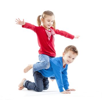 brother and sister having fun with each other - isolated on white