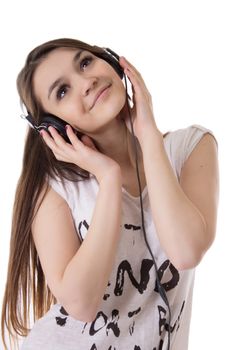 Joyful teen girl with headphones listens to the music over white