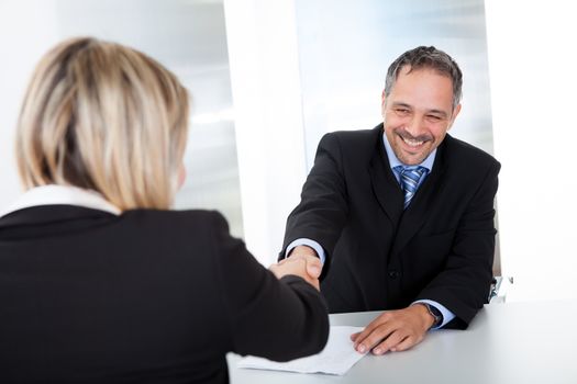 Portrait of successful businessman at the interview shaking hands