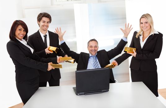 Portrait of happy businessman receiving gold bars