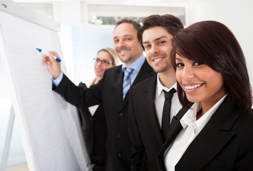 Group of business people looking at the graph on flipchart