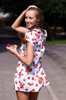 Portrait of the beautiful girl with a strawberry