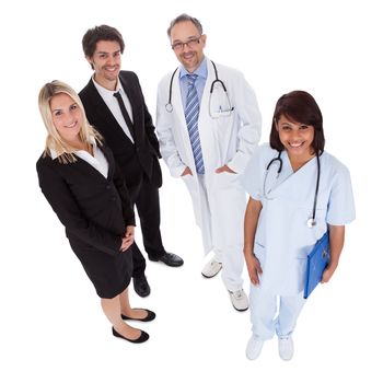 Portrait of businesspeople and medical workers standing on white background