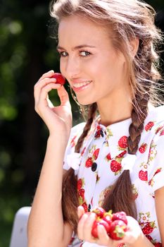 Portrait of the beautiful girl with a strawberry
