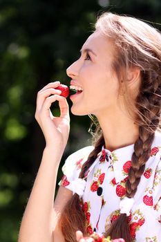 Portrait of the beautiful girl with a strawberry
